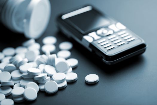 calling for medical help: white pills and mobile phone