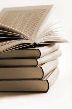 pile of books with one book open