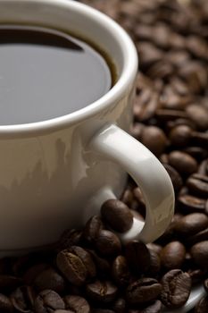 white cup of coffee and coffee beans