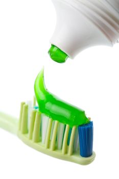 toothbrush, green toothpaste and tube isolated