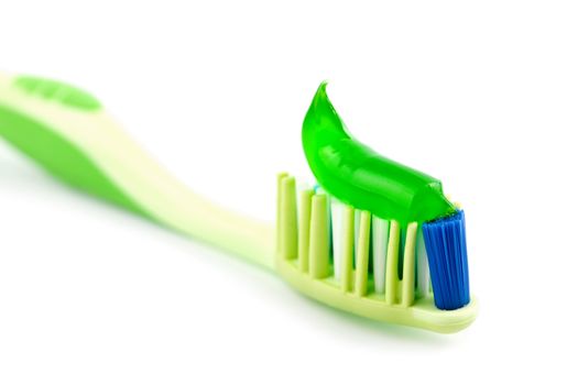 toothbrush with green toothpaste isolated
