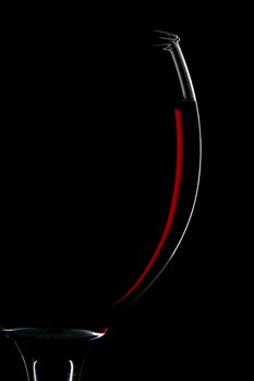 half of red wine glass isolated on black