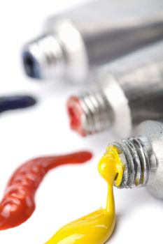 colorful paints squeezed from tubes isolate