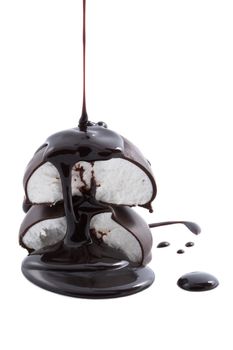chocolate syrup being poured onto marshmallows