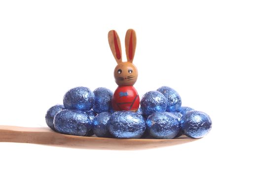 Easter eggs simply offered on a wooden spoon isolated on a white background 