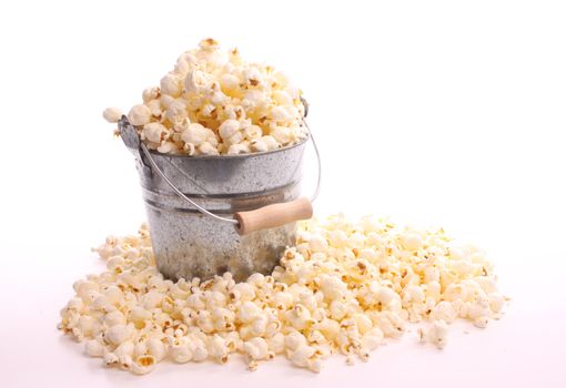 Popcorn in a bucket against a white background