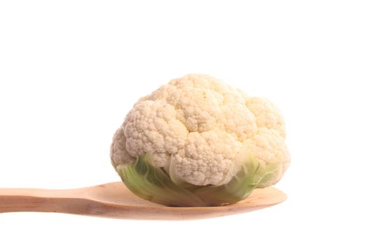 Mini cauliflower simply offered on a wooden spoon isolated on a white background 