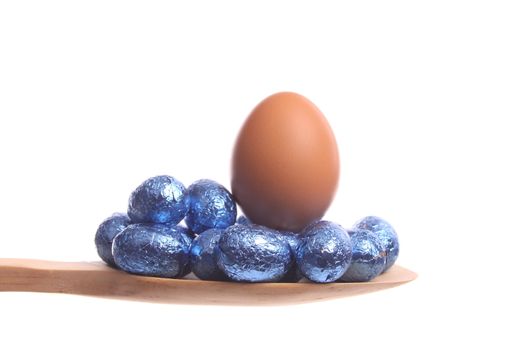 Easter eggs simply offered on a wooden spoon isolated on a white background 
