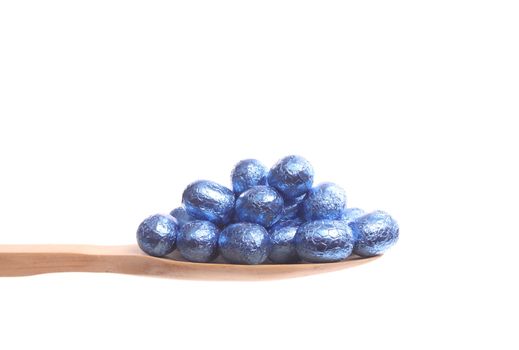 Easter eggs simply offered on a wooden spoon isolated on a white background 