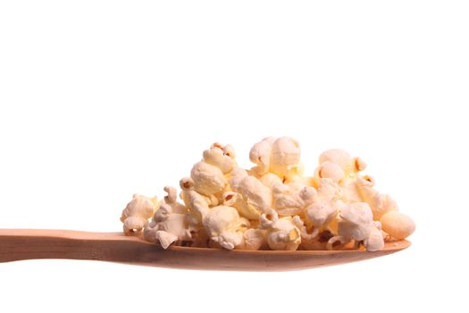 Popcorn  simply offered on a wooden spoon isolated on a white background 