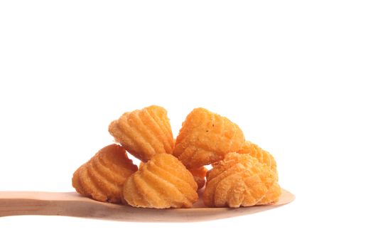 Fried potatoes  simply offered on a wooden spoon isolated on a white background 