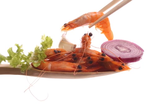 Shrimp  simply offered on a wooden spoon isolated on a white background 