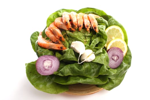 Boiled shrimps  on a dish against a white background
