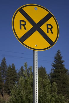 A rail road sign in the forest