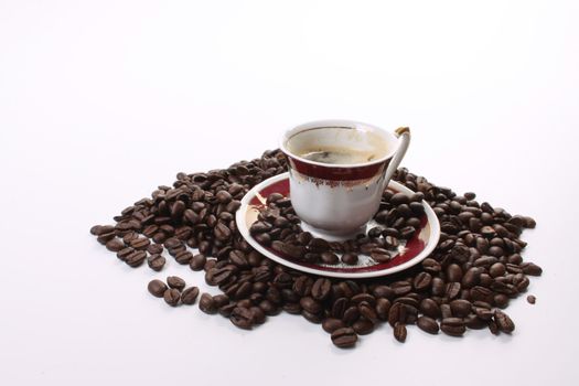 Roasted coffee beans  and a coffee cup 
