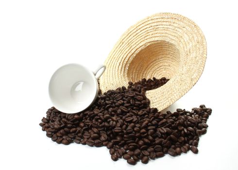 Roasted coffee beans  and a coffee cup  and a straw hat