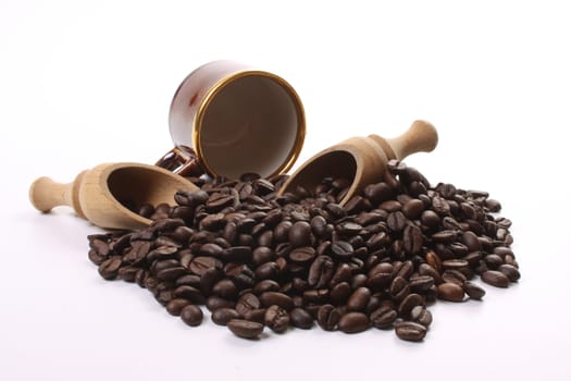 Roasted coffee beans  and a coffee cup and scoops
