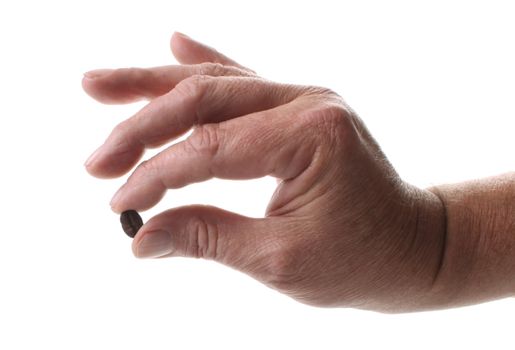 Roasted coffee beans  and a hand with a coffee bean