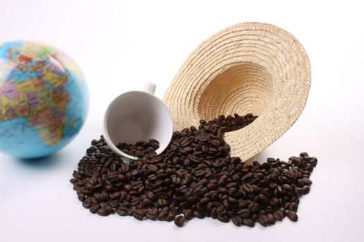 Roasted coffee beans  and a coffee cup, a straw hat and a globe