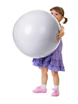 The little girl has a huge ball isolated on white background