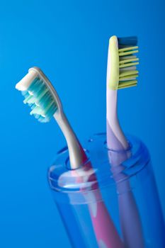
two colorful toothbrushes