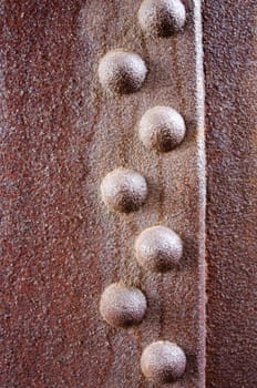 rivets on a rusty metal sheet