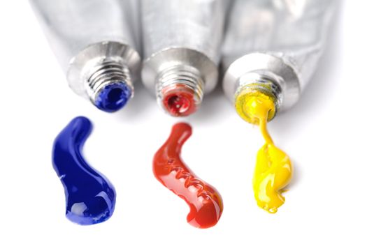 colorful paints squeezed from tubes isolated