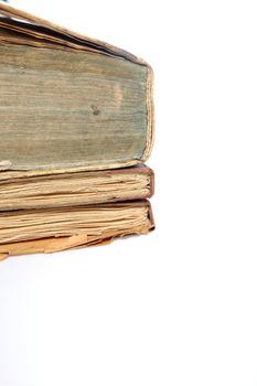 Pile of three old discoloured vintage books with worn pages, partial view isolated on white