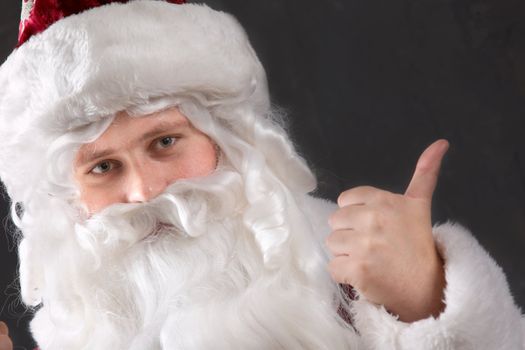 An image of Santa Claus showing his thumb