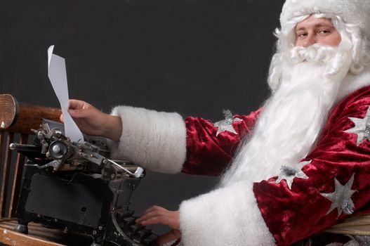 Santa Claus typing a letter on an typewriter