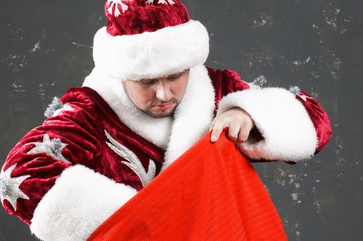 Santa Claus is preparing to celebrate Christmas. With red bag