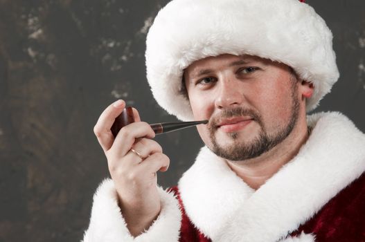 Santa Claus is preparing to celebrate Christmas. Smoking