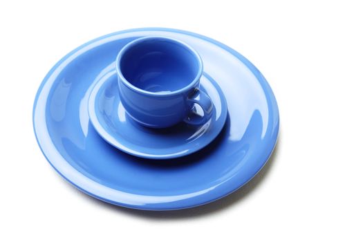 Blue plates and teacup on a white background