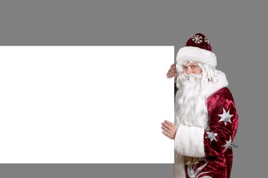 Santa Claus carrying a white shield for advertisement