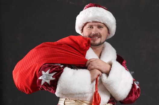 Santa Claus carrying a bag with gifts