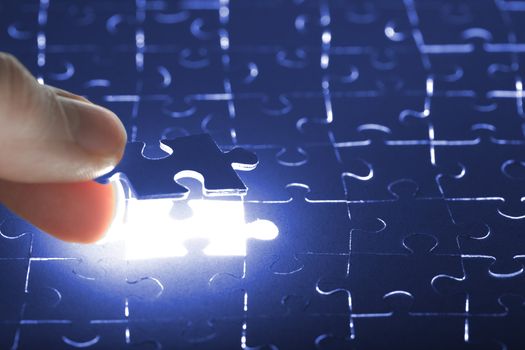 hand holding puzzle piece