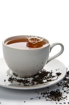 tea splash in white cup isolated