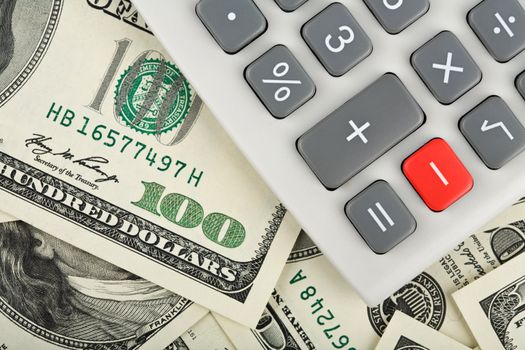 calculator with minus red button over dollars