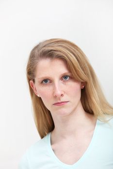 Pretty blonde girl with long hair looking slightly put out about some incident.