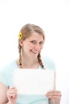 Pretty blonde with braids and a yellow daisy in her hair, holding up a blank sheet of paper