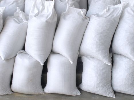 Pile of white sacks full with sand and rock