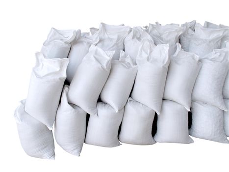 Pile of white sacks full with sand and rock isolated with clipping path