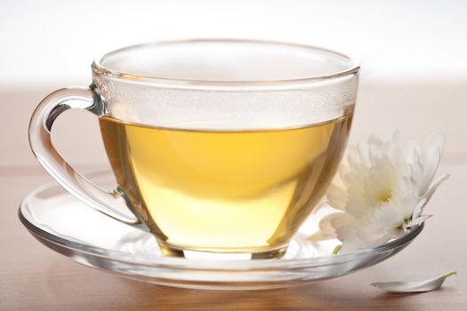 cup of green tea and white flower
