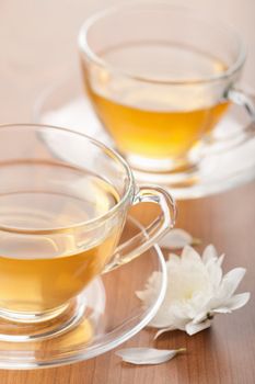 cup of green tea and white flower
