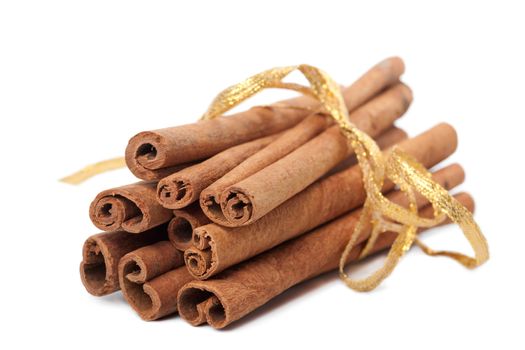 cinnamon with golden ribbon isolated