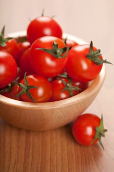 ripe tomatoes in wooden bowl
