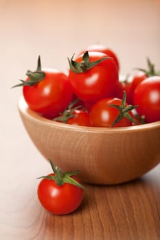 ripe tomatoes in wooden bowl
