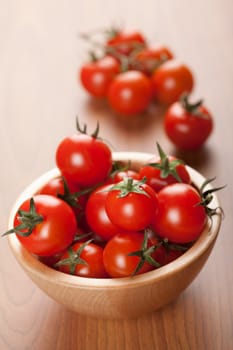 ripe tomatoes in wooden bowl
