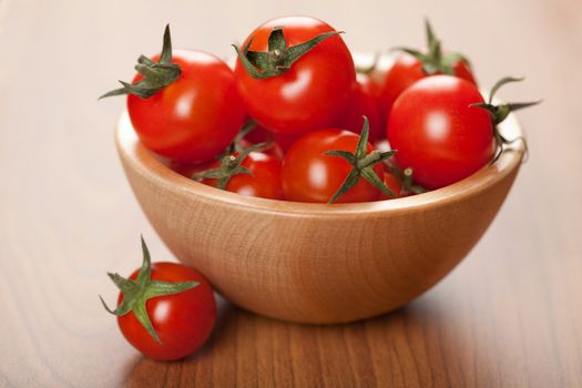 ripe tomatoes in wooden bowl

