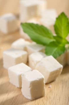 feta cheese on wooden cutting board 
